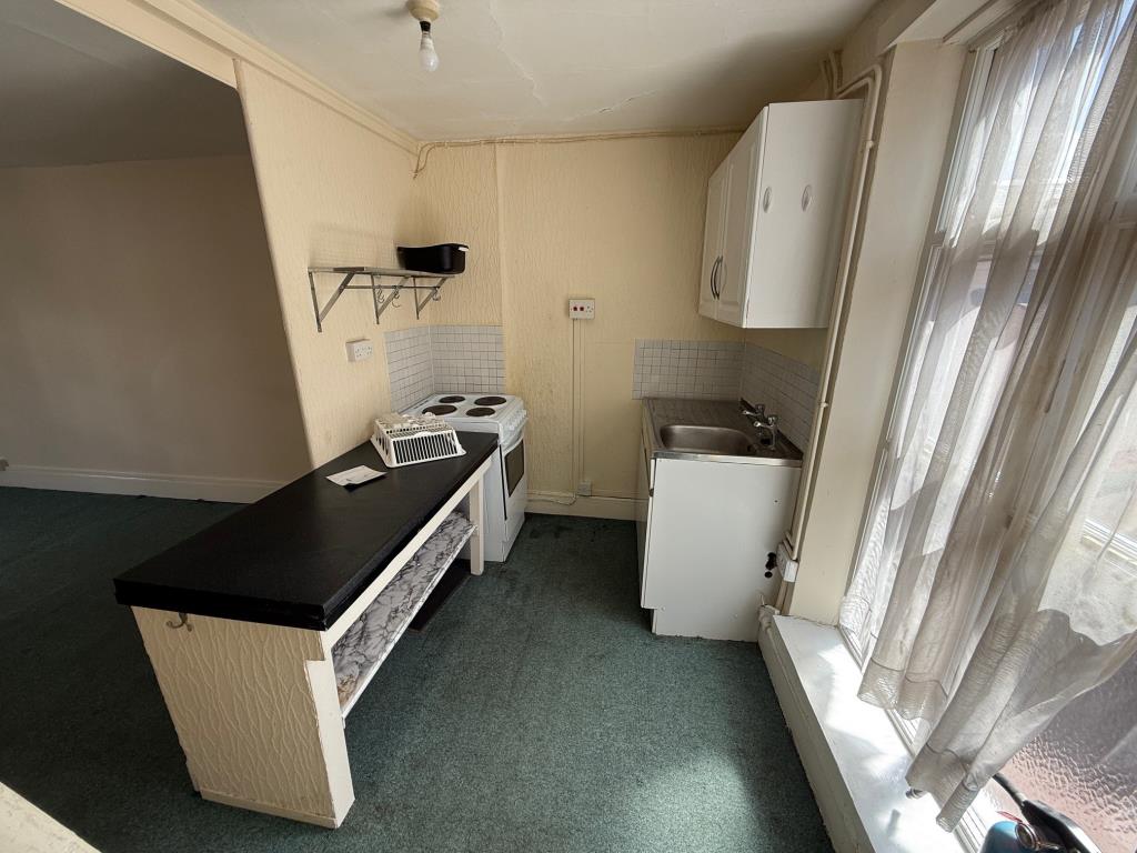 Lot: 88 - MIXED USE BUILDING FOR IMPROVEMENT AND REPAIR - Kitchen area with window to rear